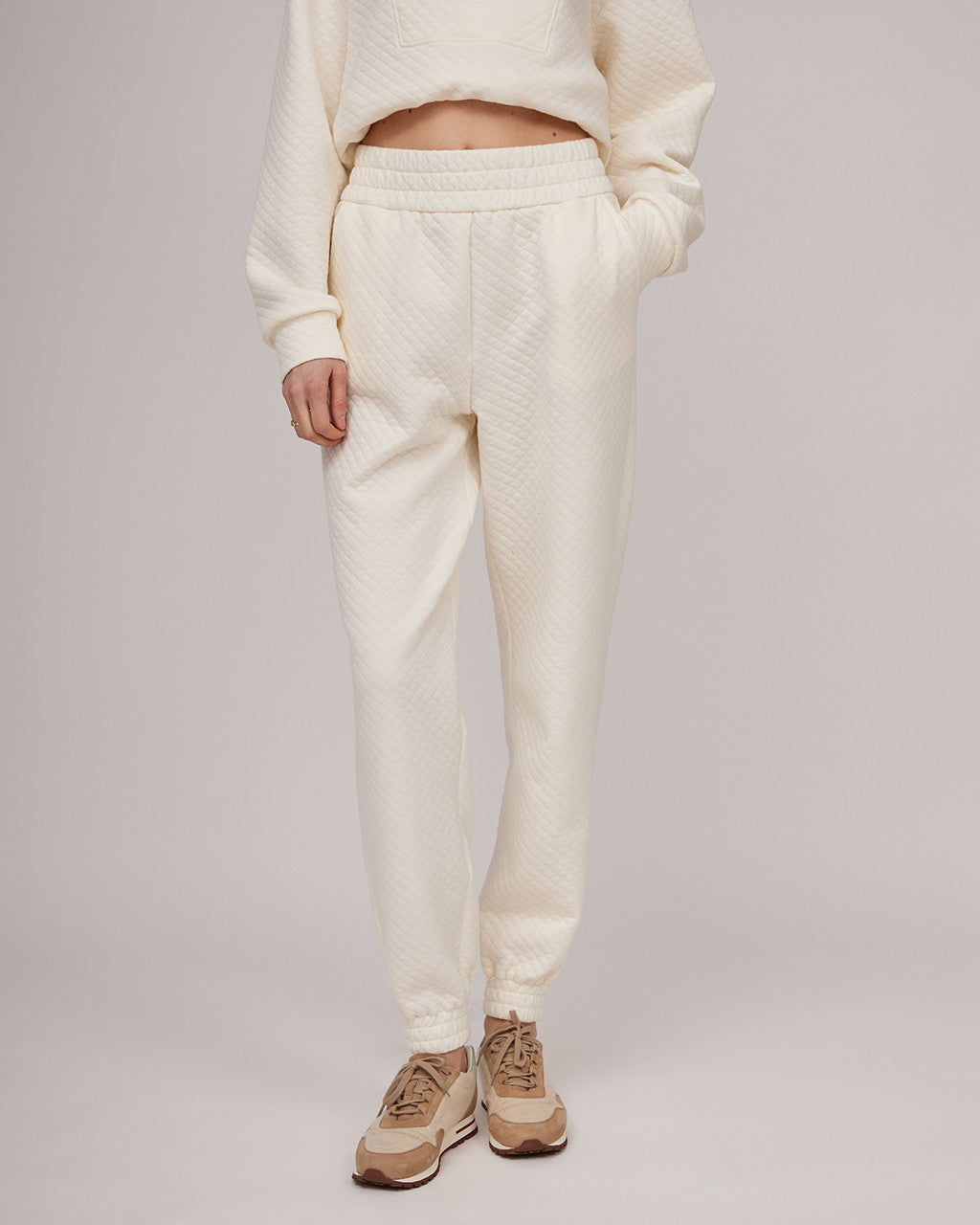 Cream-colored soft cotton casual trousers with a slight