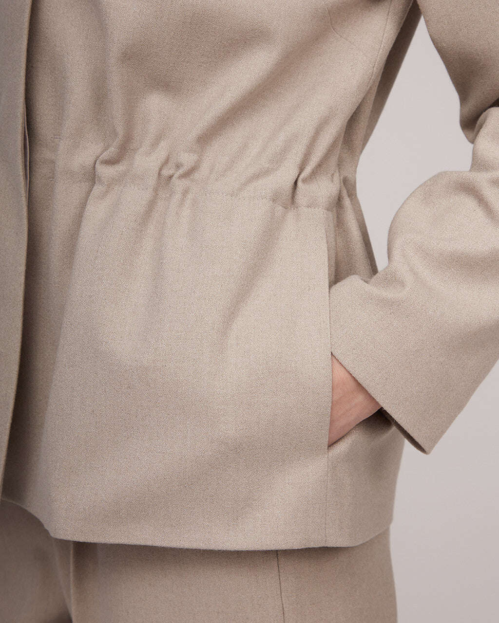 Light beige tweed jacket with a cinched waist | NERINA Nolo Store